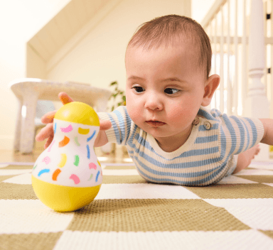 Baby playing with the Sliding Top Box from The Thinker Play Kit